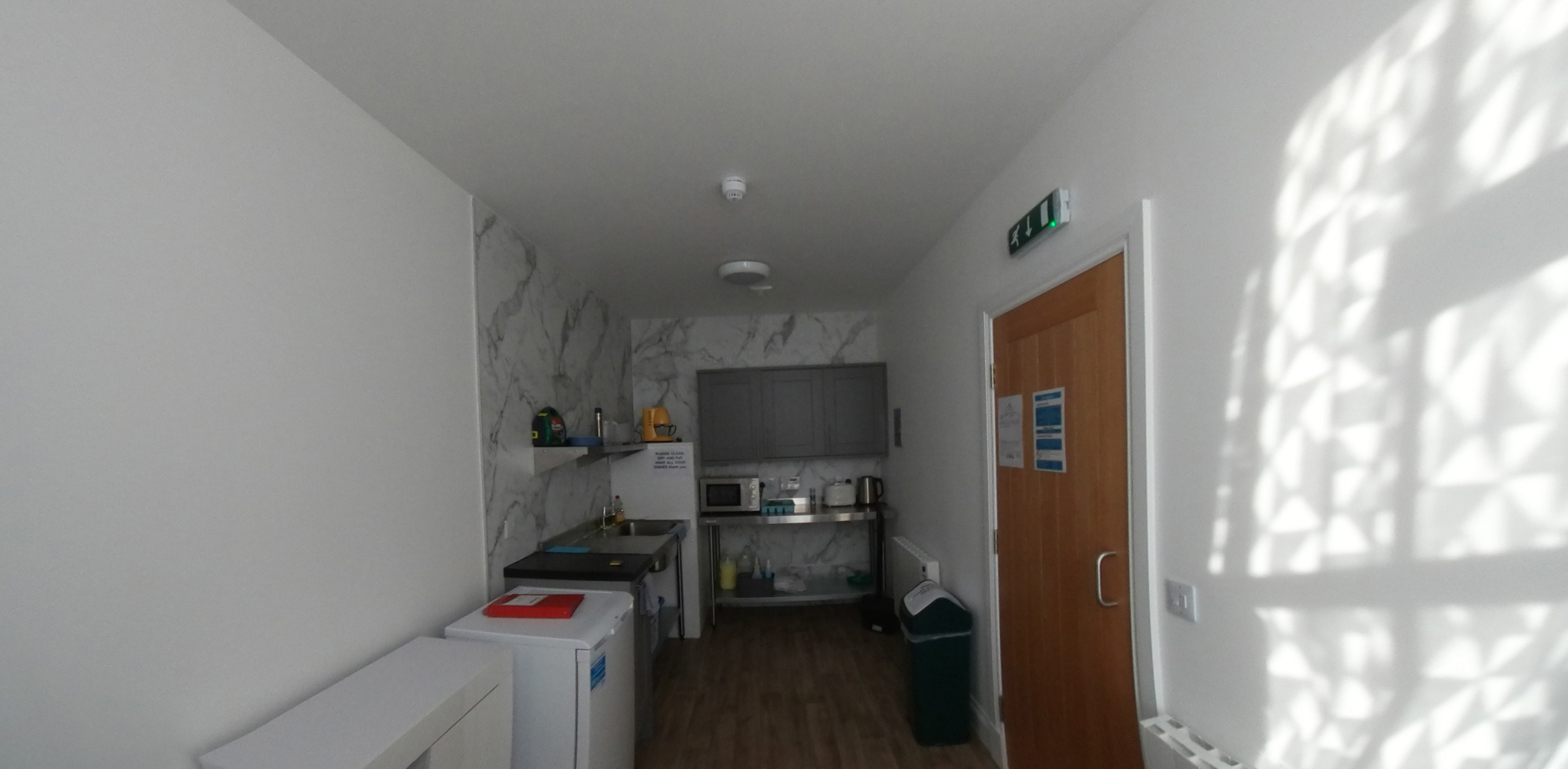 Photo of kitchen area with sink, work surface and bin